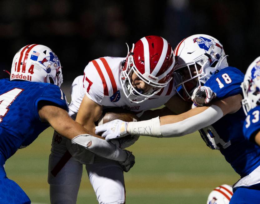 Liberty center back Isaiah Hampton (14) and line backer La'akea Louis (18) defend Mater Dei wid ...