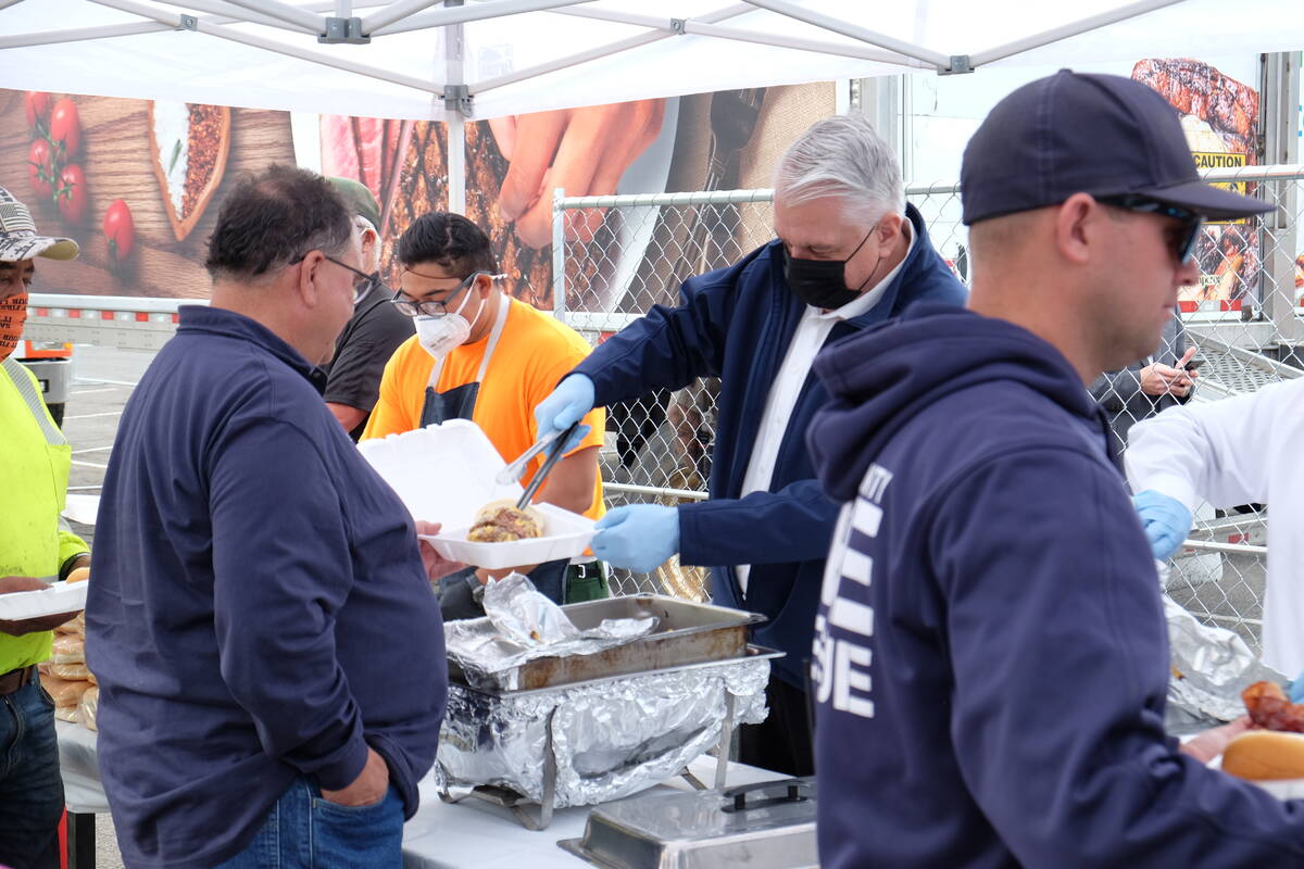 Gov. Steve Sisolak serving up double cheeseburgers for firefighters at the Hard Rock Hotel stag ...