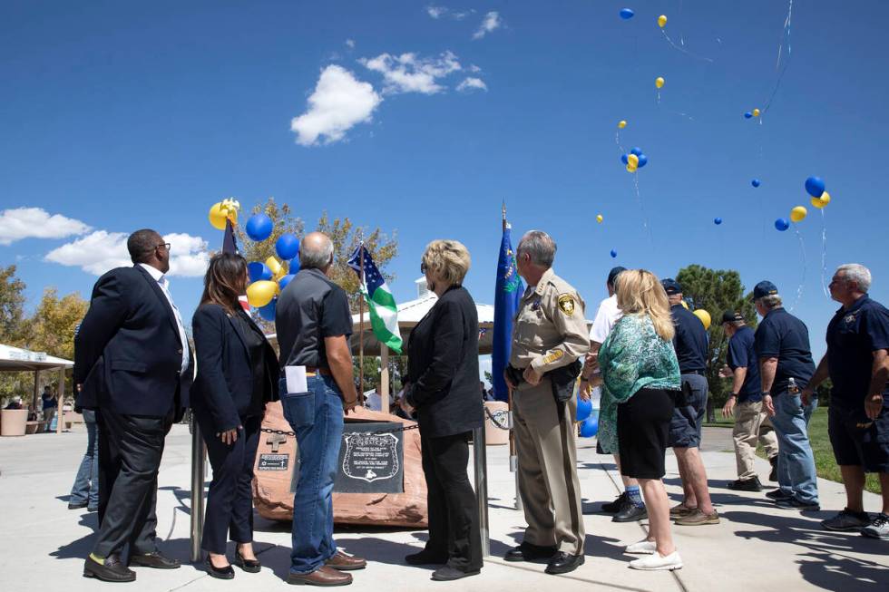 Local government leadership watches as balloons are released in honor of the first responders w ...