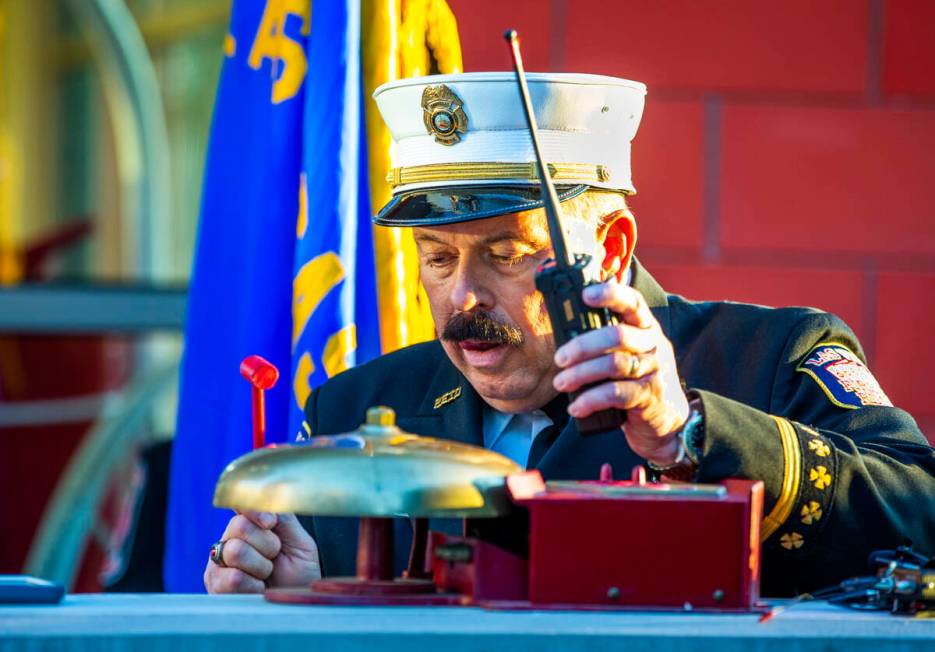 Las Vegas Fire Public Education and Information Officer Tim Szymanski strikes the bell, Saturd ...