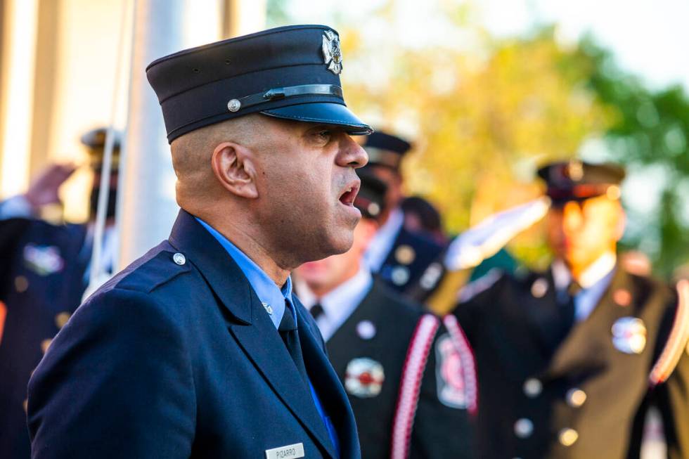 Retired New York City firefighter Frank Pizarro sings the national anthem, Saturday, Sept. 11, ...