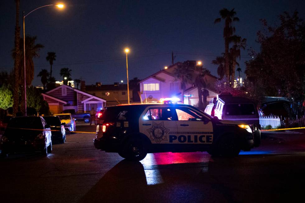 Las Vegas police officers investigate the scene of homicide on Montcliff Avenue in Spring Valle ...