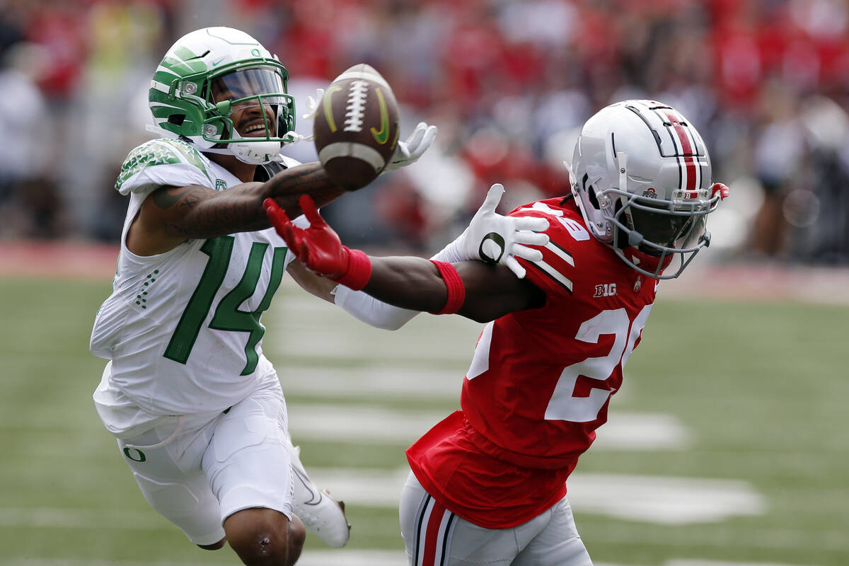 Ohio State defensive back Denzel Burke, right, breaks up a pass intended for Oregon receiver Kr ...