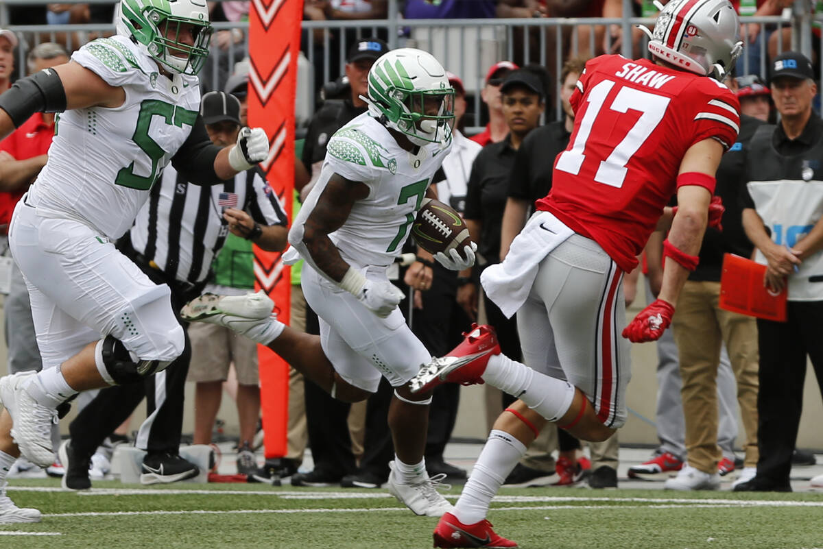 Oregon running back CJ Verdell, center, scores a touchdown against Ohio State during the first ...