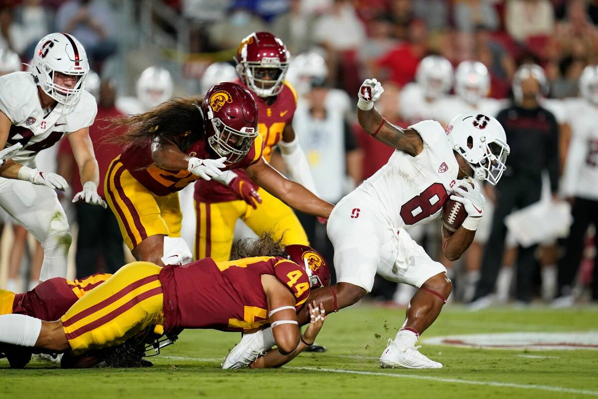 Stanford running back Nathaniel Peat (8) is tackled by Southern California linebacker Tuasivi N ...