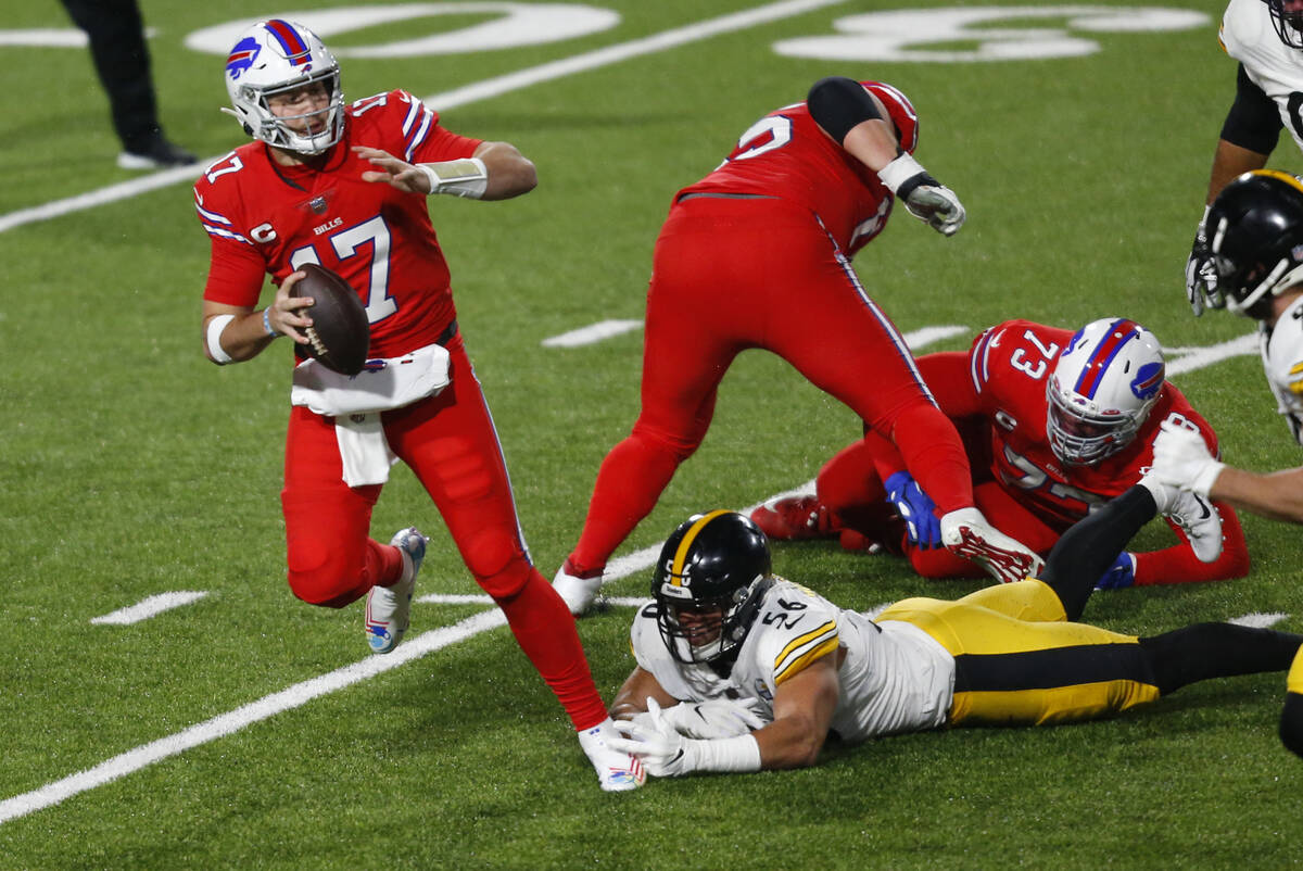 Buffalo Bills quarterback Josh Allen (17) is forced out of the pocket by Pittsburgh Steelers li ...