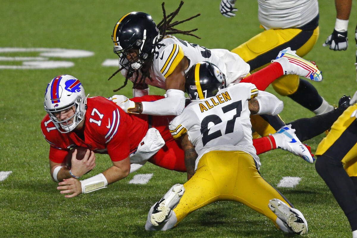 Buffalo Bills quarterback Josh Allen (17) is tackled by Pittsburgh Steelers strong safety Terre ...
