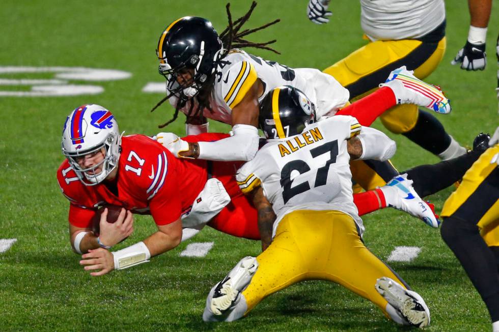 Buffalo Bills quarterback Josh Allen (17) is tackled by Pittsburgh Steelers strong safety Terre ...