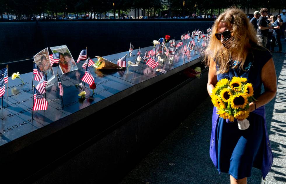 Flags adorn the inscribed names of the victims of Sept. 11, 2001, at the National September 11 ...