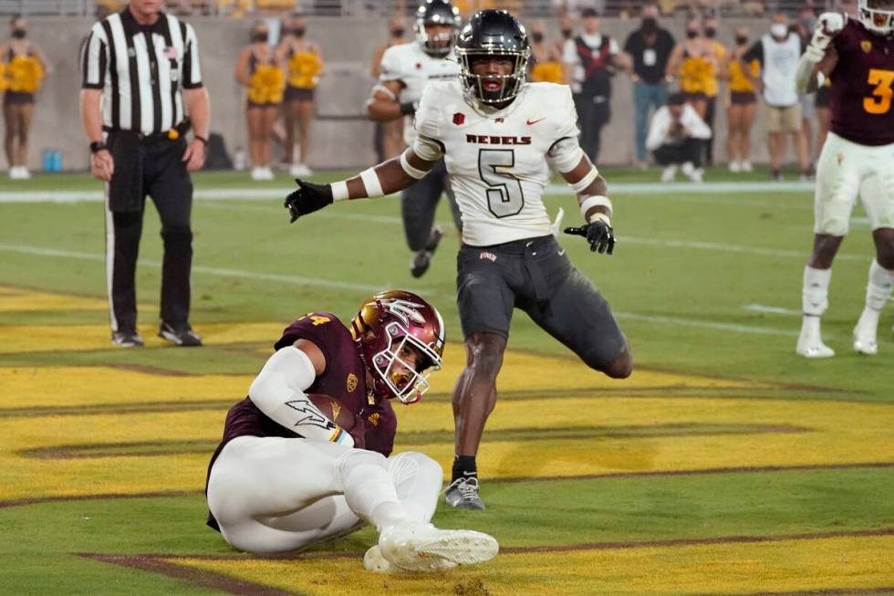 Arizona State wide receiver Johnny Wilson (14) pulls in a touchdown as UNLV defensive back Phil ...