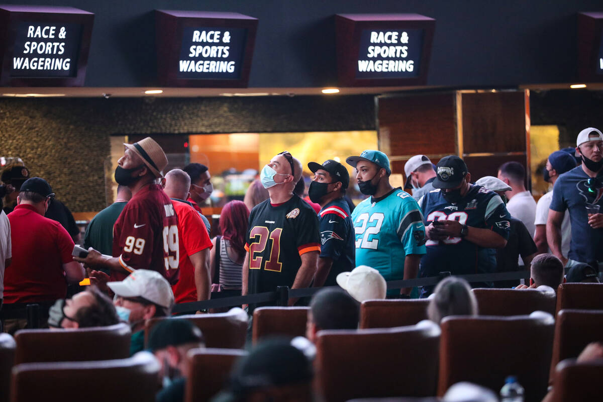 Guests wait in line to place their bets at the Sports Book at Westgate in Las Vegas, Sunday, Se ...