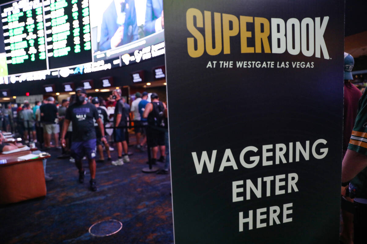 Guests wait in line to place their bets at the Sports Book at Westgate in Las Vegas, Sunday, Se ...