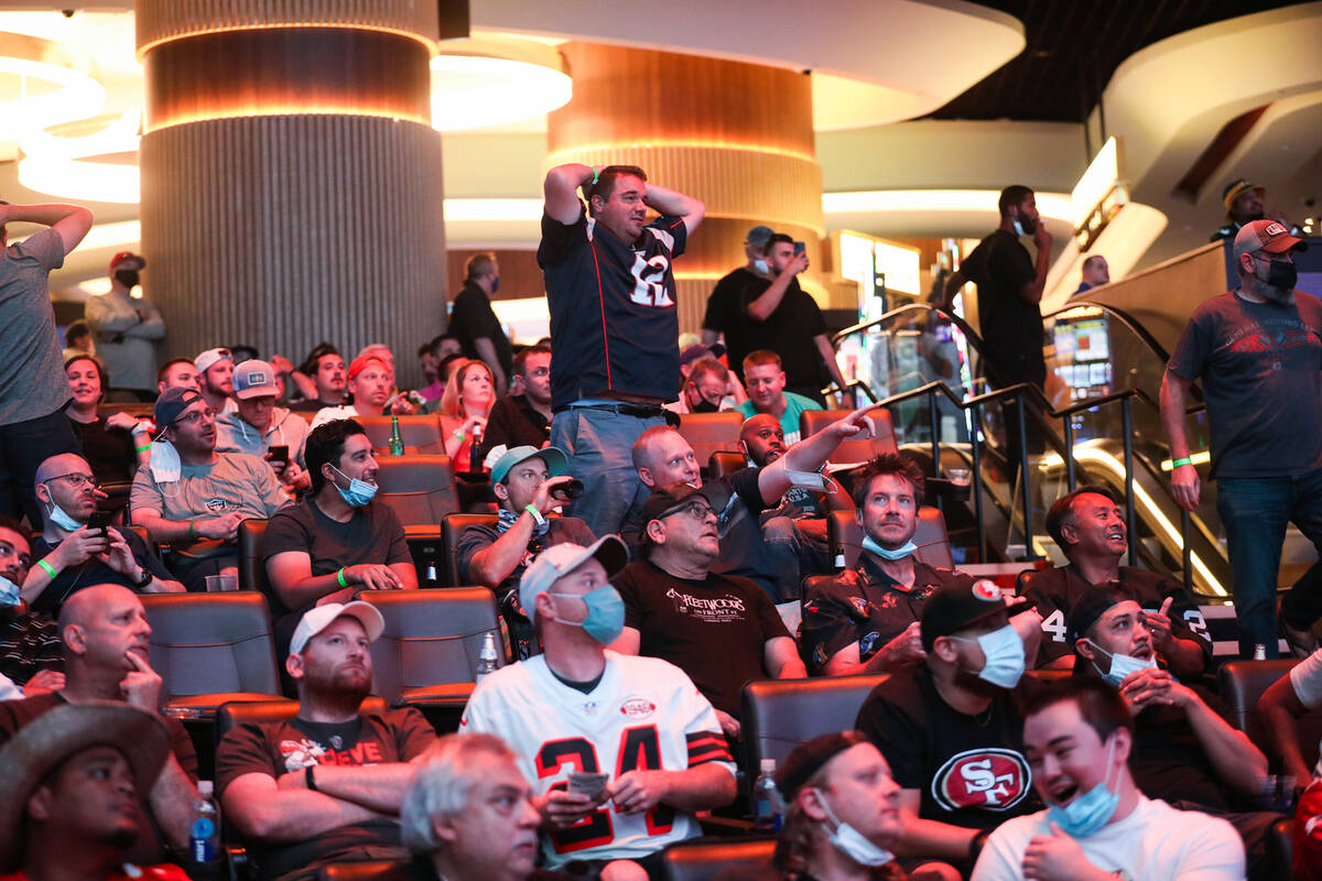 Guests watch the screens for the first week of the NFL season at the Sportsbook at Circa in Las ...