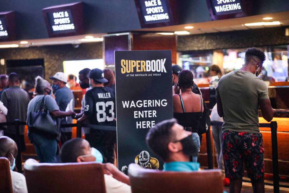 Guests wait in line to place their bets at the Sports Book at Westgate in Las Vegas, Sunday, Se ...