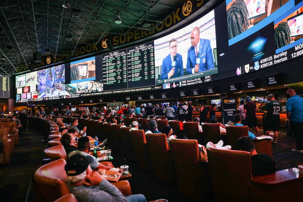 A packed house watches the screens at the Sports Book at Westgate in Las Vegas, Sunday, Sept. 1 ...