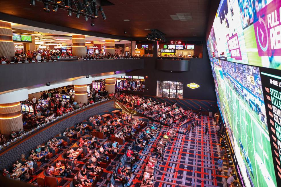 Guests watch the screens for the first week of the NFL season at the Sportsbook at Circa in Las ...