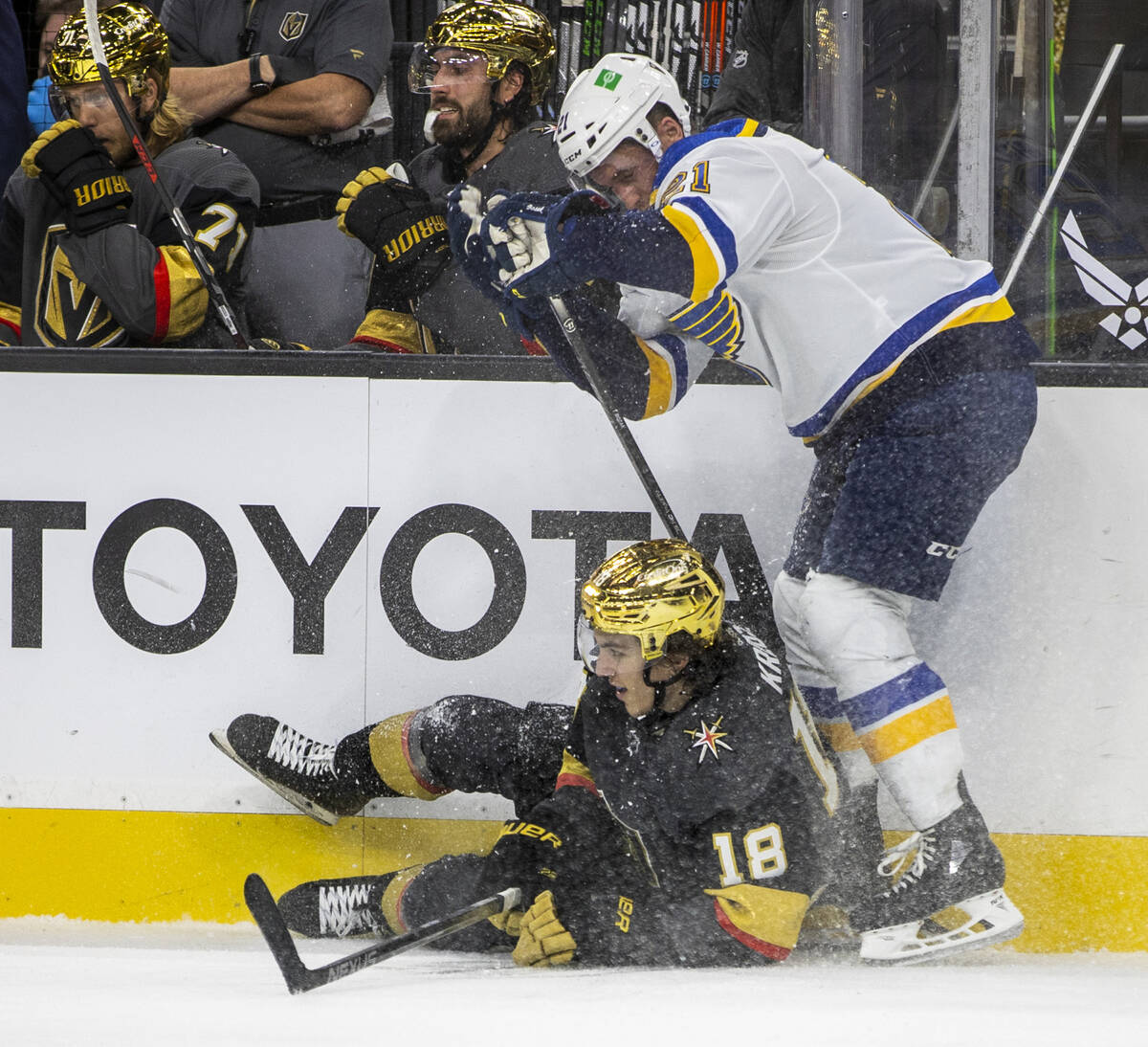 Golden Knights left wing Peyton Krebs (18) is taken down on the ice by St. Louis Blues center T ...