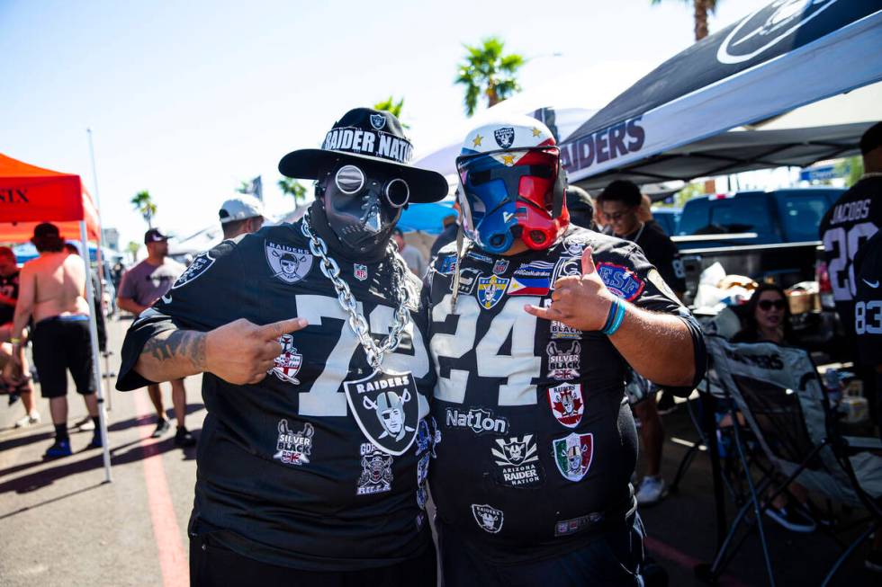 Raiders fans Phillip Prieto, left, and Gene Biyok pose for a portrait during a tailgate before ...
