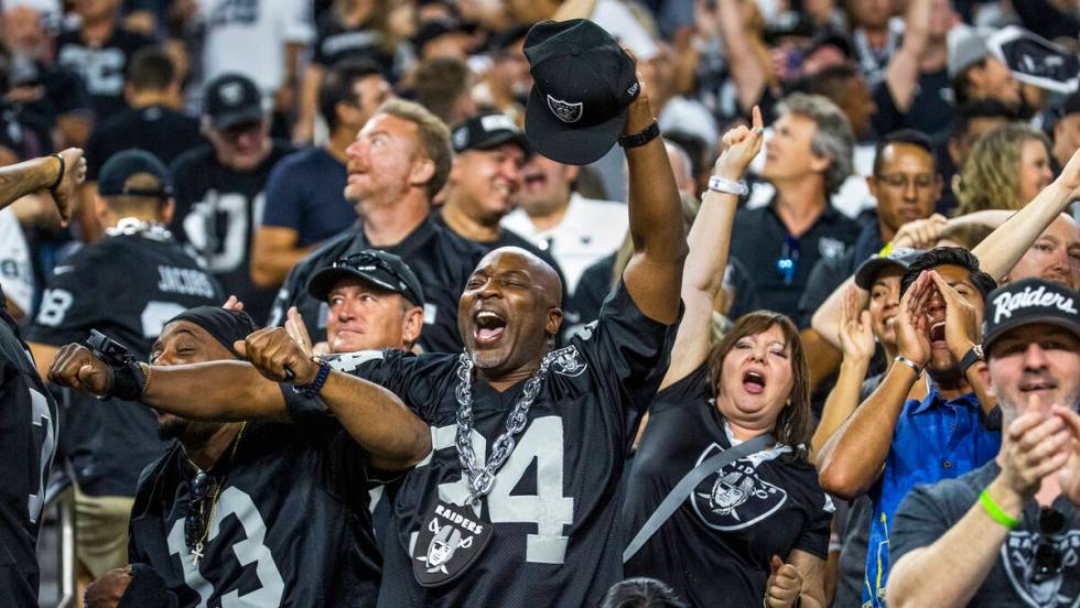 Raiders fans celebrate a tie scoring drive versus the Baltimore Ravens during the fourth quarte ...