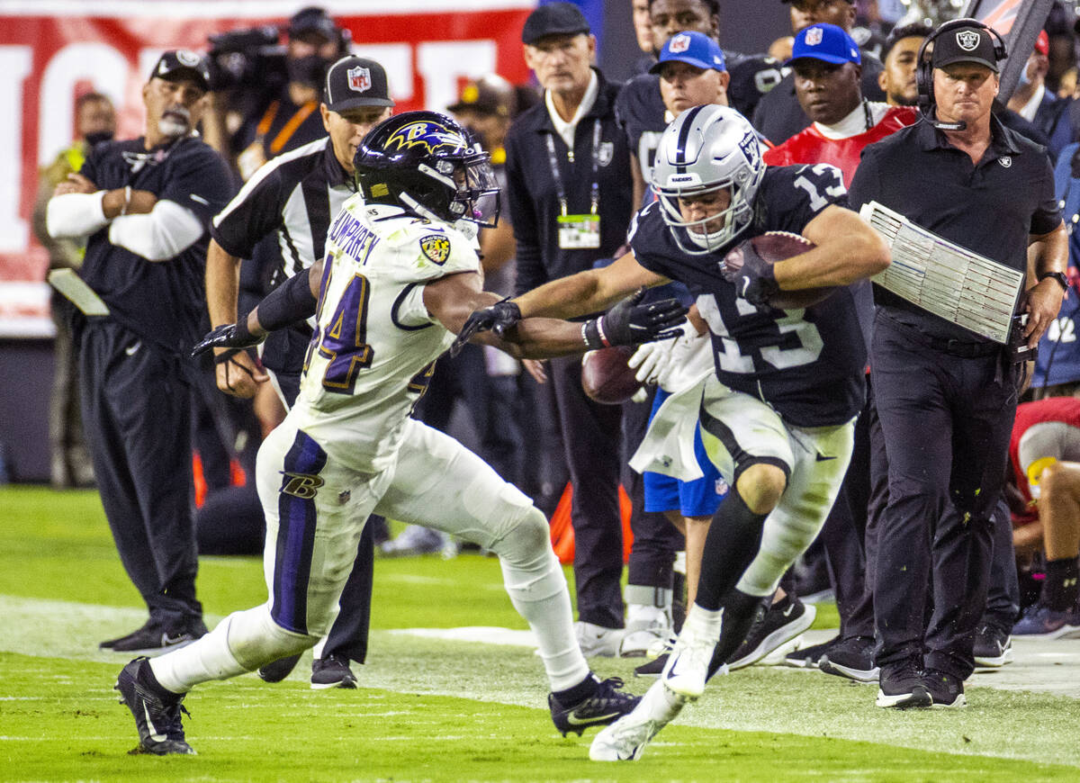 Raiders wide receiver Hunter Renfrow (13) escapes down the sidelines as Baltimore Ravens corner ...