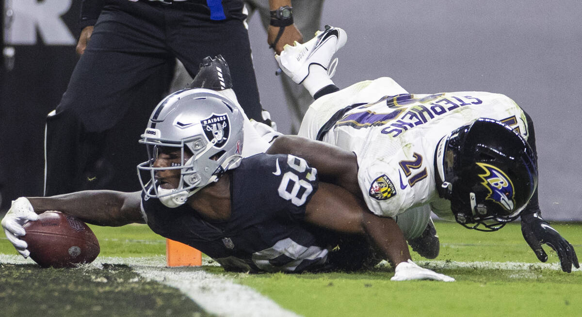 Raiders wide receiver Bryan Edwards (89) extends to try to score a touchdown against Baltimore ...