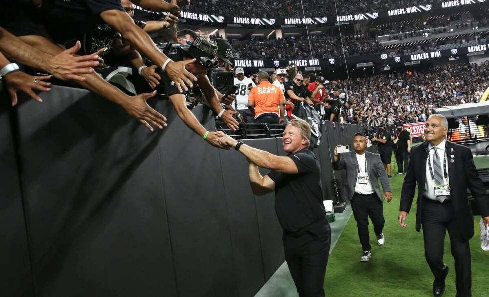 Raiders head coach Jon Gruden celebrates with fans after an overtime win against the Baltimore ...