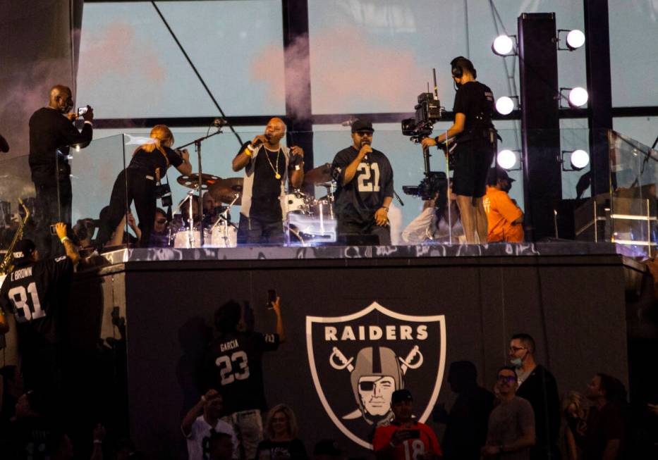 Too Short, center left, and Ice Cube perform during halftime at an NFL game between the Raiders ...