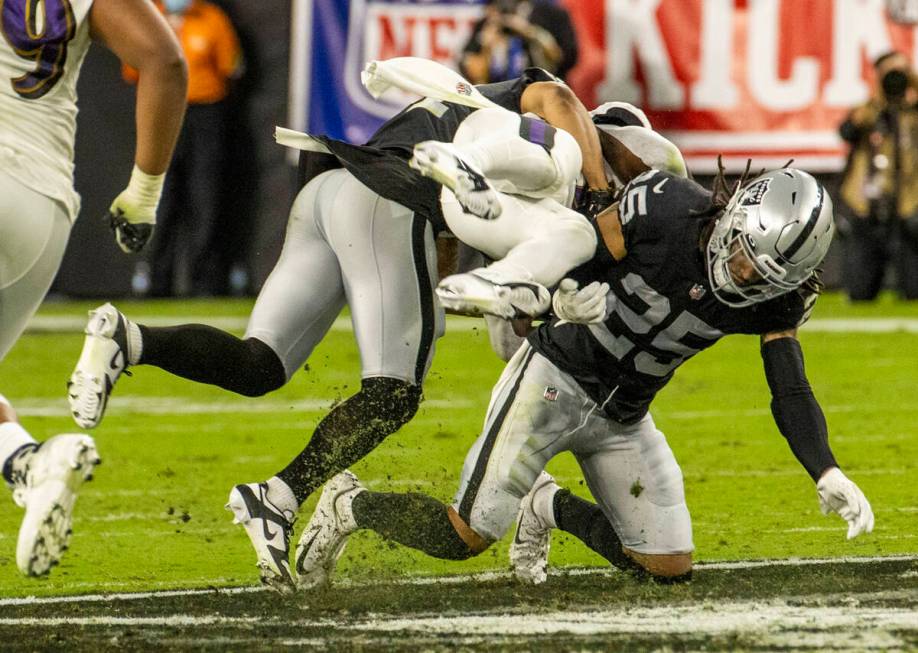 Baltimore Ravens running back Ty'Son Williams (34) upended by Raiders safety Trevon Moehrig (25 ...