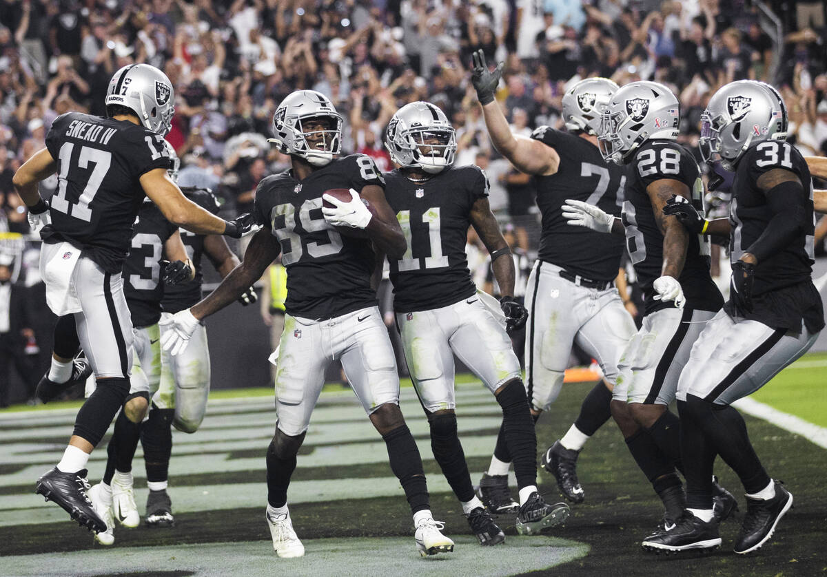 Raiders wide receiver Bryan Edwards (89) celebrates a big play with teammates in overtime durin ...