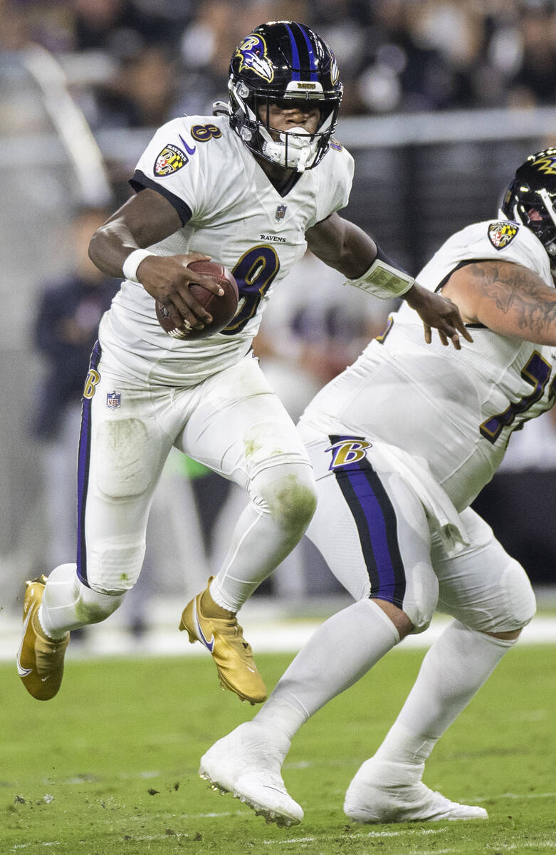 Baltimore Ravens quarterback Lamar Jackson (8) sprints up field in the third quarter during an ...