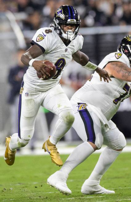 Baltimore Ravens quarterback Lamar Jackson (8) sprints up field in the third quarter during an ...