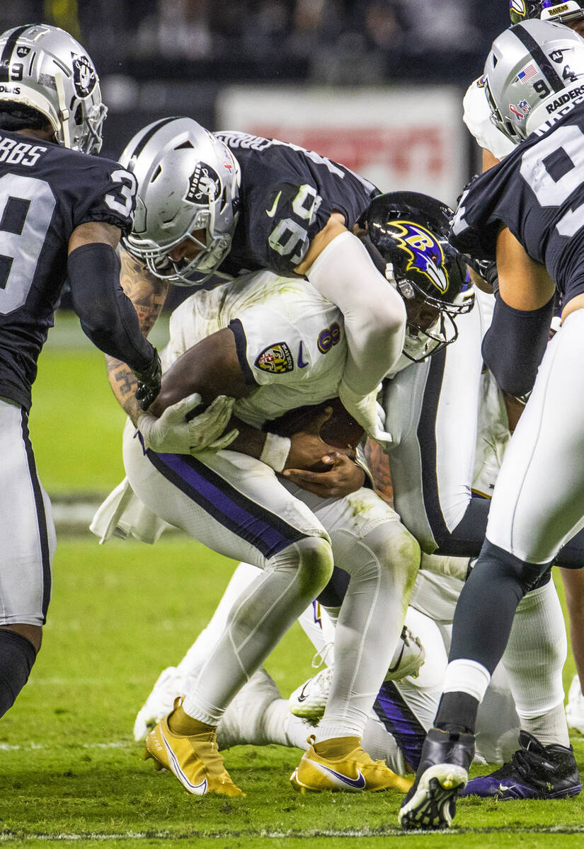 Raiders defensive end Maxx Crosby (98) sacks Baltimore Ravens quarterback Lamar Jackson (8) dur ...