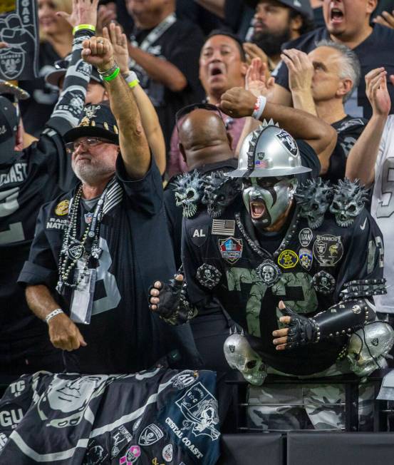 A Raiders fans cheer during the first quarter of an NFL football game against the Baltimore Rav ...
