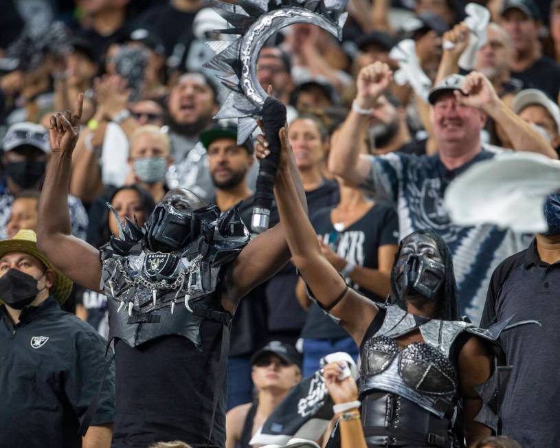A pair of costumed Raiders fans rally the crowd during the second quarter of an NFL football ga ...