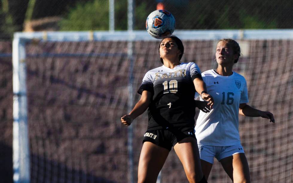 Faith Lutheran’s Andrea Leyva (10) and Arbor View’s Isabella Srodes (16) fight fo ...