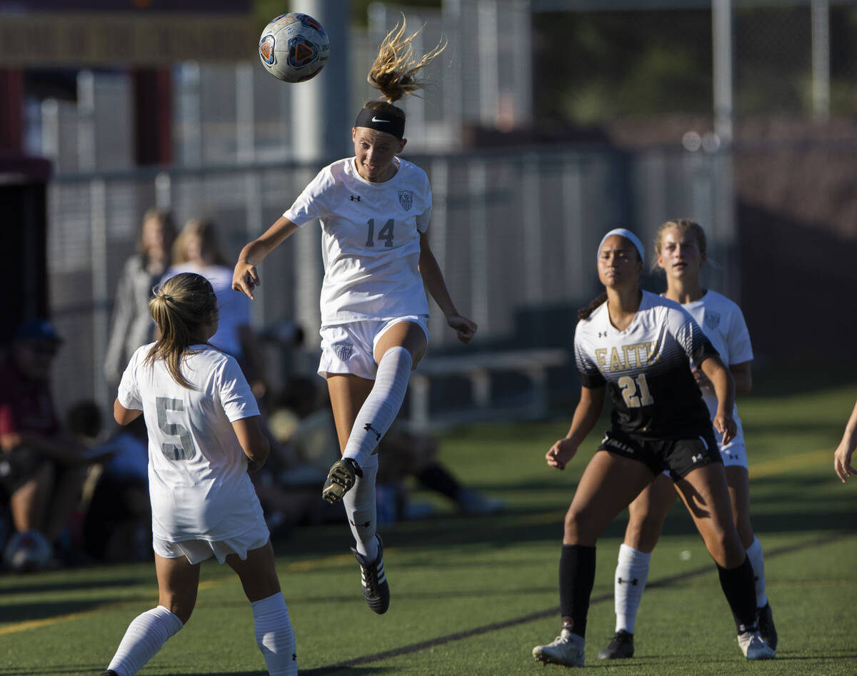 Arbor View’s Madison Little (14) heads the ball to teammate Taya Bohenko (5) with Faith ...