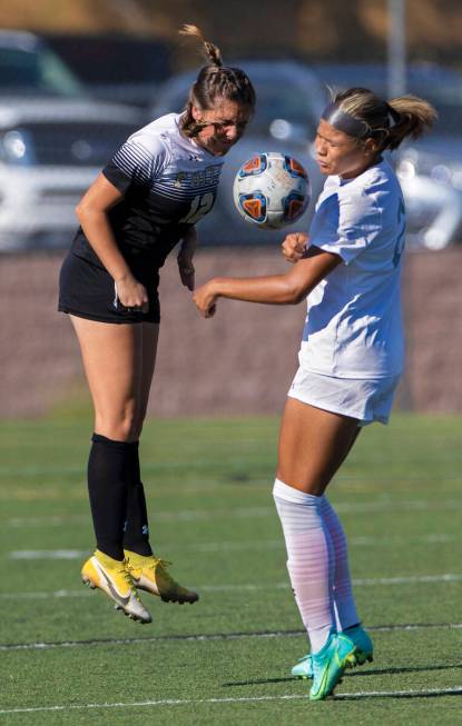 Arbor View’s Tiana Beavers (23) and Faith Lutheran’s Lindley Amick (12) fight for ...