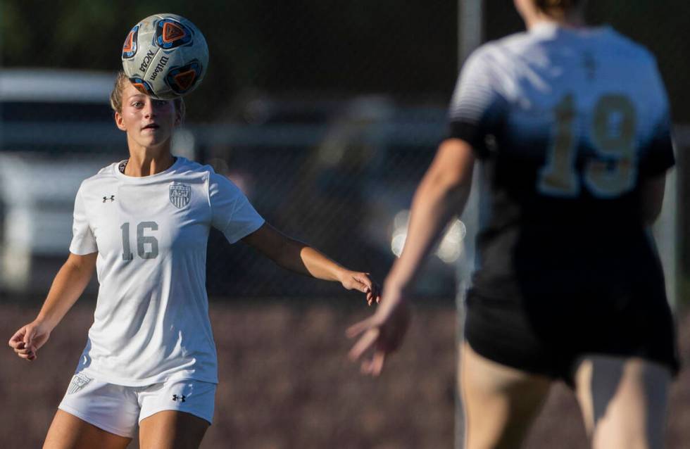 Arbor View’s Isabella Srodes (16) heads a ball with Faith Lutheran’s Charlotte Mc ...