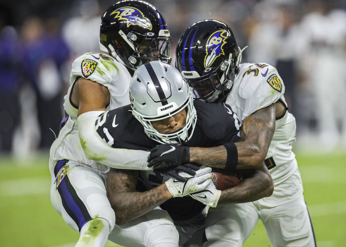 Raiders tight end Darren Waller (83) is tackled by Baltimore defenders in the third quarter dur ...