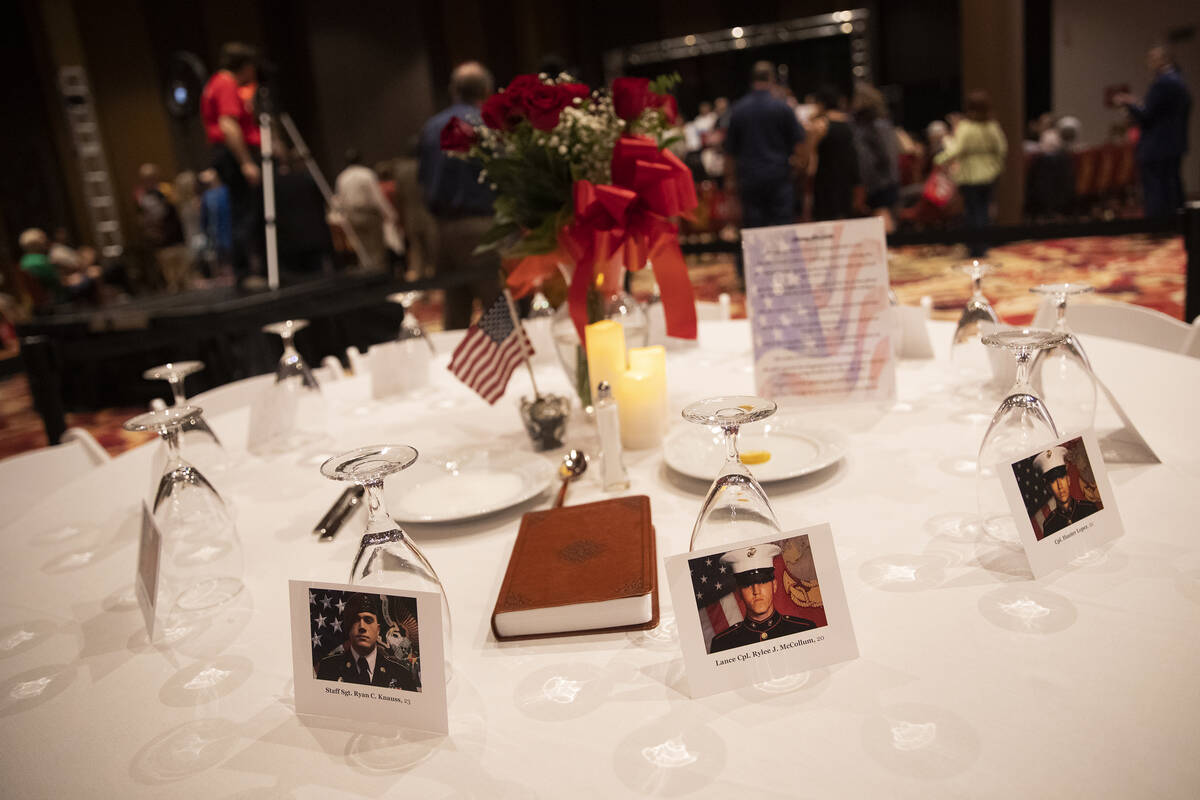 A table is set with photos of the thirteen United States service members killed during the Kabu ...