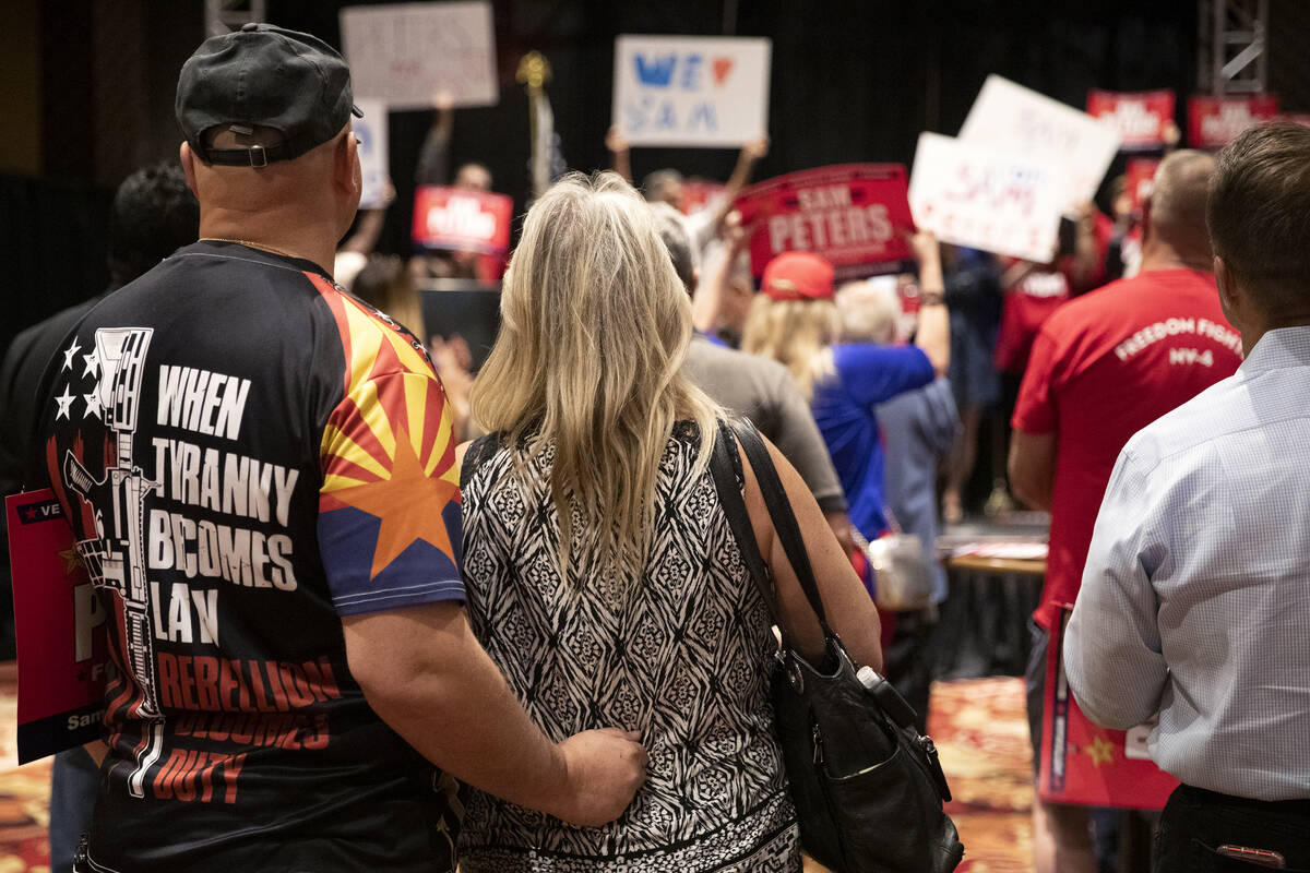 An attendee wears a shirt saying "when tyranny becomes law rebellion becomes duty" du ...