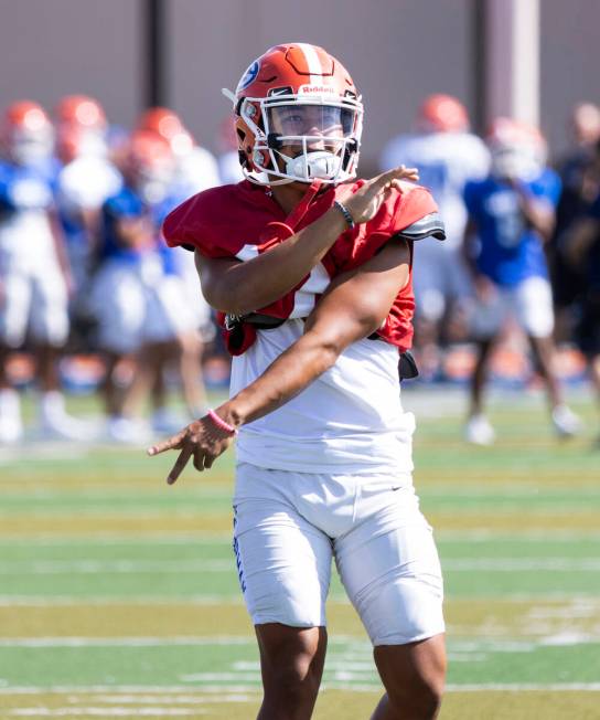 Bishop Gorman High School quarterback Micah Alejado watches his throw during team's practice, o ...