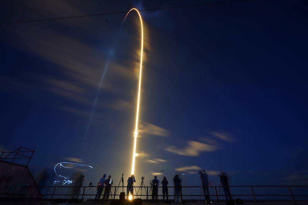 A SpaceX Falcon 9 rocket, with four private citizens onboard, lifts off in this time-exposure p ...