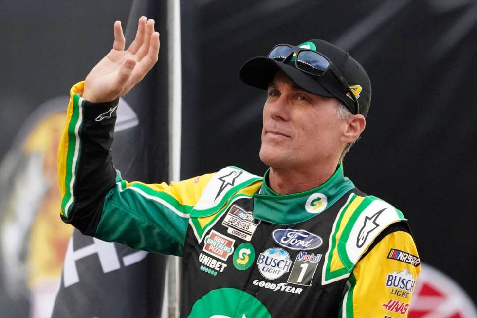 Kevin Harvick waves to fans before a NASCAR Cup Series auto race at Bristol Motor Speedway Satu ...