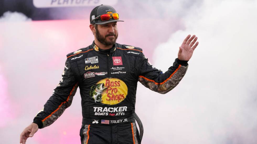 Martin Truex Jr. waves to the crowd during driver introductions prior to the start of the NASCA ...