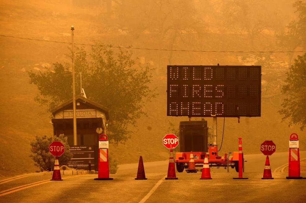 Cones block the entrance to Sequoia National Park, Calif., as the KNP Complex Fire burns nearby ...