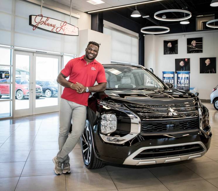 UFC Heavyweight Champion Francis Ngannou stands in front of the 2022 Outlander at Johnny Legend ...