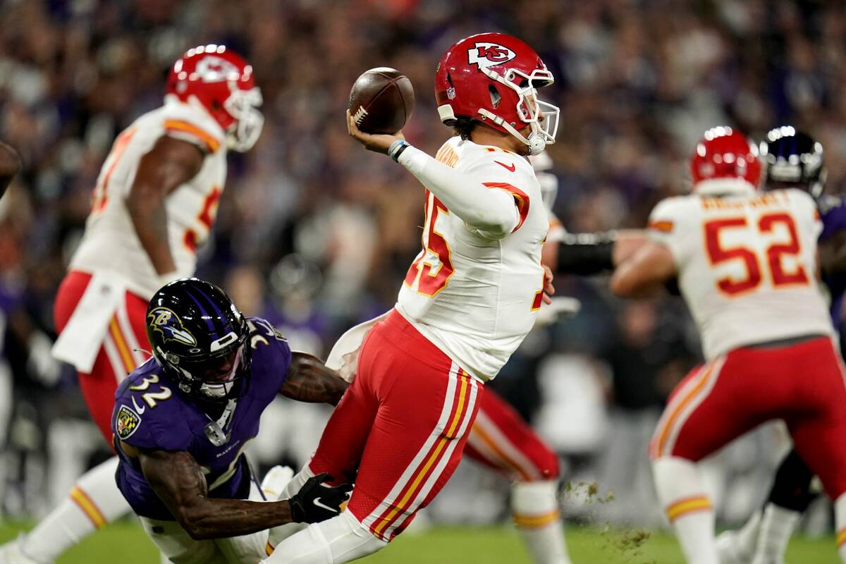 Kansas City Chiefs quarterback Patrick Mahomes attempts to throw a pass as he is pressured by B ...