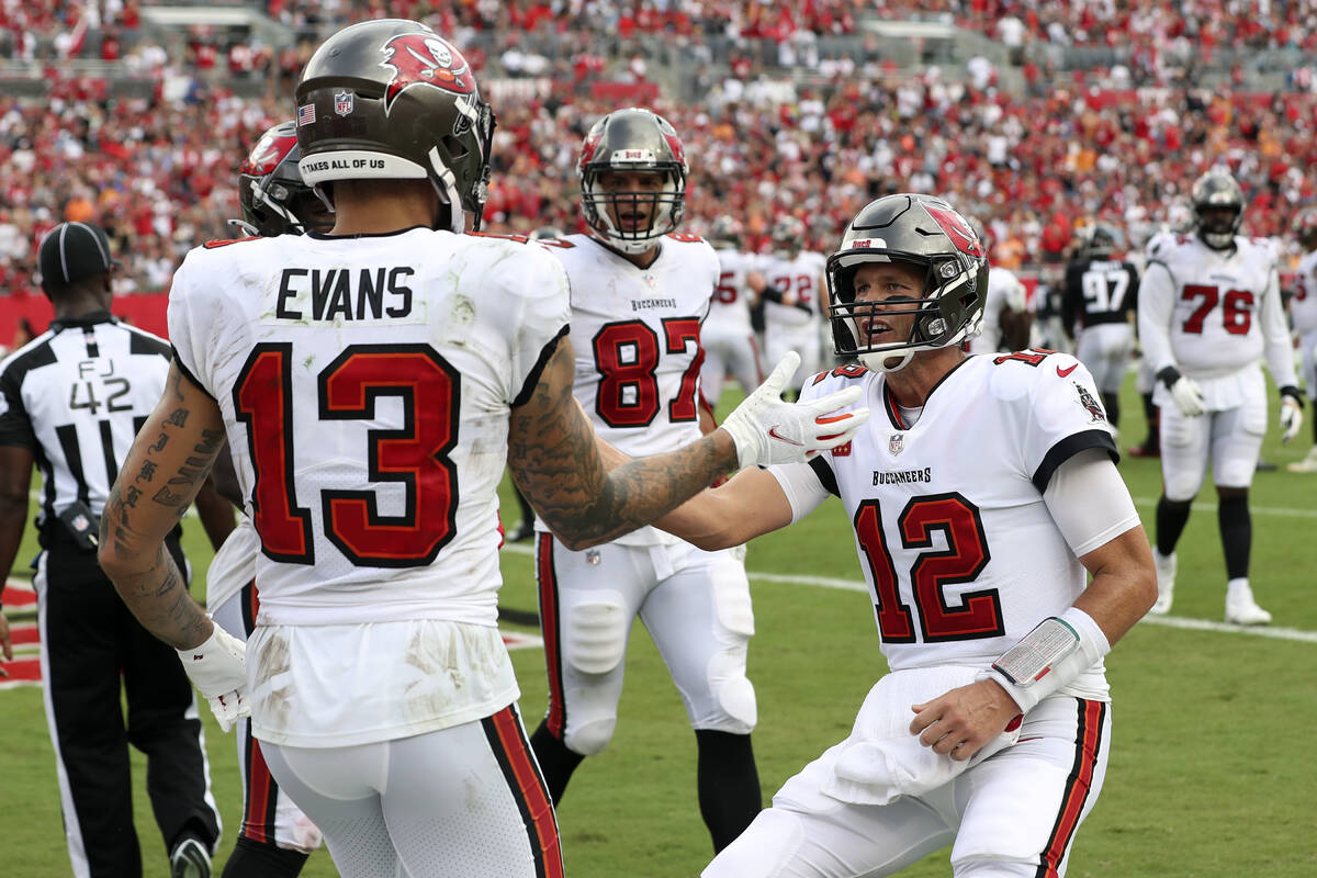 Tampa Bay Buccaneers quarterback Tom Brady (12) celebrates with wide receiver Mike Evans (13) a ...