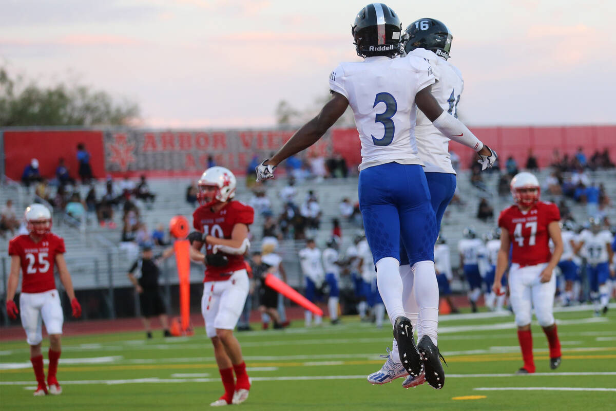 Desert Pines Lavon Brown (3) celebrates a touchdown with Alex Swift (16) in the first half of a ...
